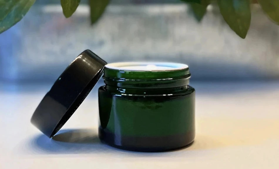 A high class face moisturizer using only all-natural ingredients in a green glass jar from Happy Lad.