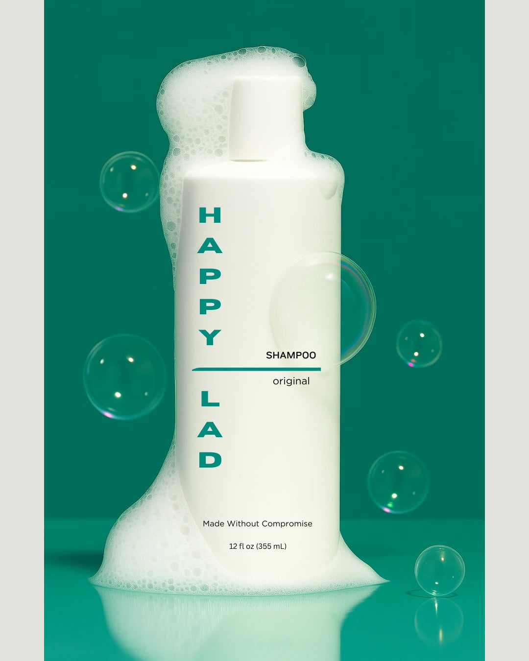 Non toxic shampoo for men by Happy Lad with soap bubbles on and around bottle.