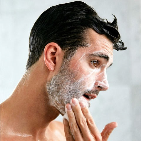 A man using a all-natural hydrating face wash made with organic ingredients free of harmful chemicals.