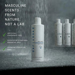 Happy Lad organic body wash bottle with shower head and water droplets on a gray marble background