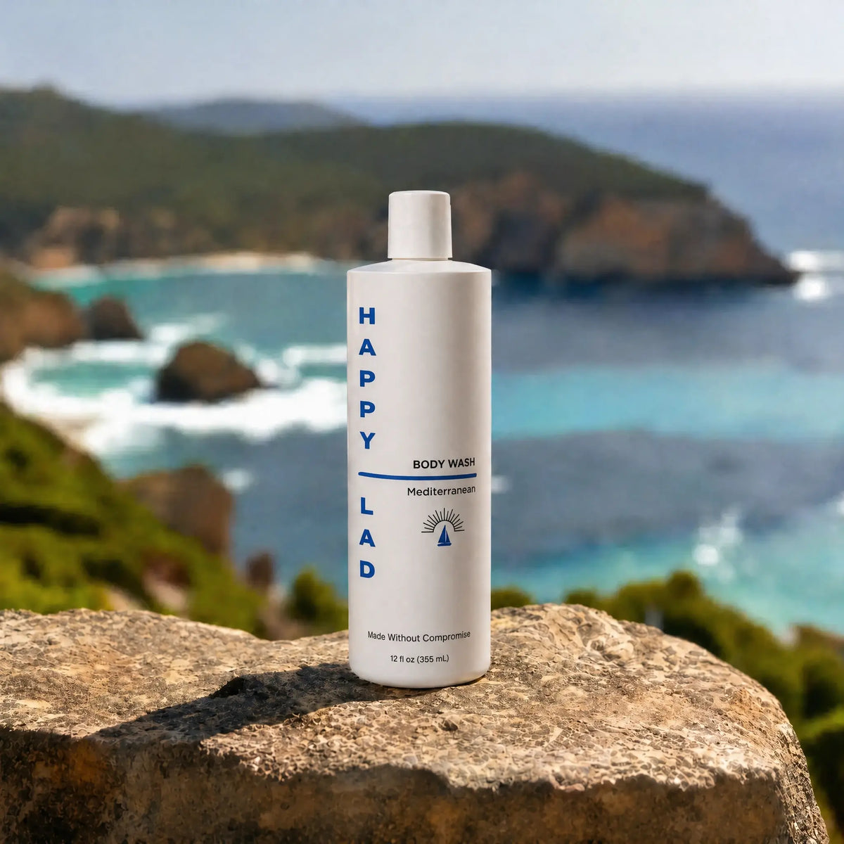 Organic mens Body Wash that is Mediterranean scented with essential oils by Happy Lad bottle on a rock with a scenic ocean view in the background.
