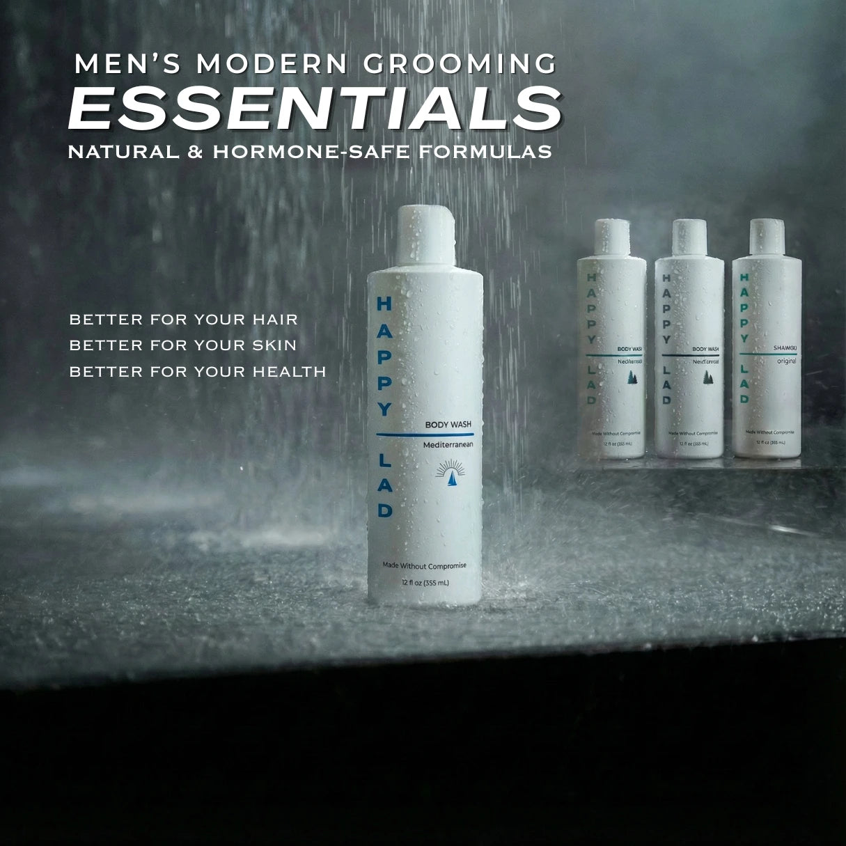 A bottle of Happy Lad Organic Body Wash stands on a dark surface under falling water, with three more bottles including Happy Lad's Natural Shampoo in the background. Large text at the top reads 'MEN'S MODERN GROOMING ESSENTIALS'