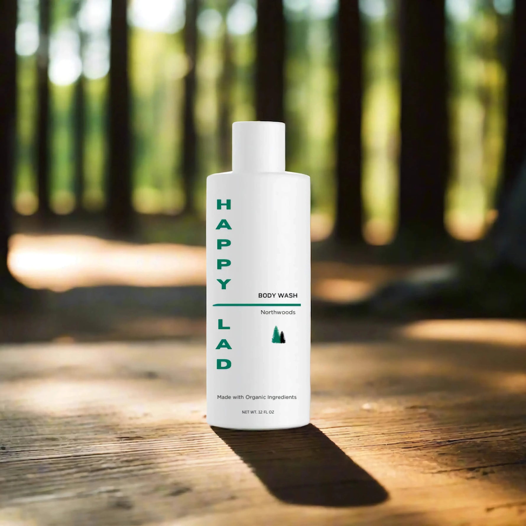 Natural body wash for men made with organic ingredients and essential oils (Northwoods), the best body wash for men by Happy Lad. Bottle on a wooden surface with a forest background